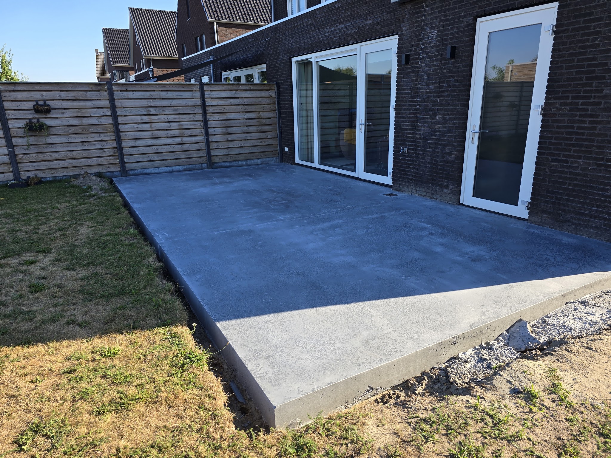 Donkere gevlinderde vloer direct tegen de woning
